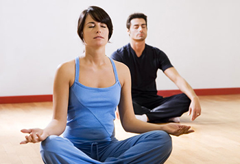 health club: man and women doing yoga.